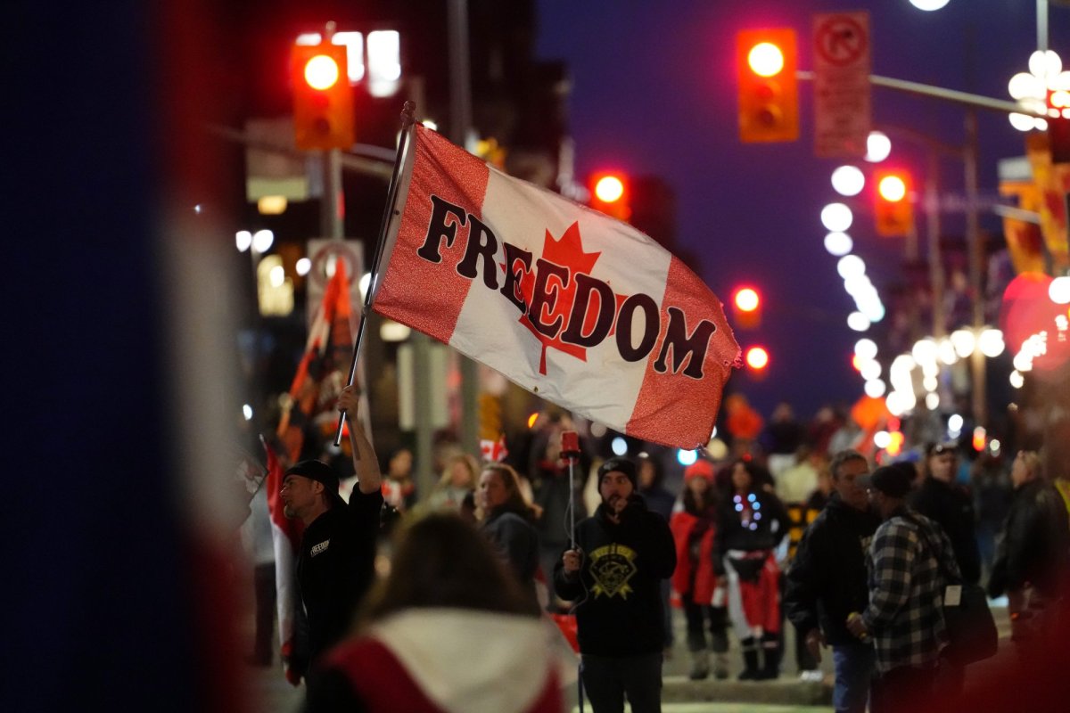 A protester waves a flag saying "freedom" during a demonstration, part of a convoy-style protest participants are calling "Rolling Thunder", in Ottawa, Friday, April 29, 2022. THE CANADIAN PRESS/Sean Kilpatrick.