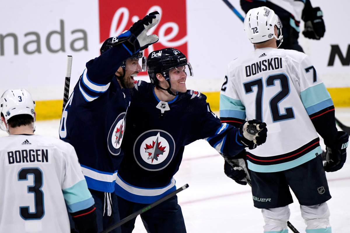 Winnipeg Jets’ Blake Wheeler (26) celebrates his goal against the Seattle Kraken with Nikolaj Ehlers (27) during the third period of NHL action in Winnipeg on Sunday May 1, 2022.