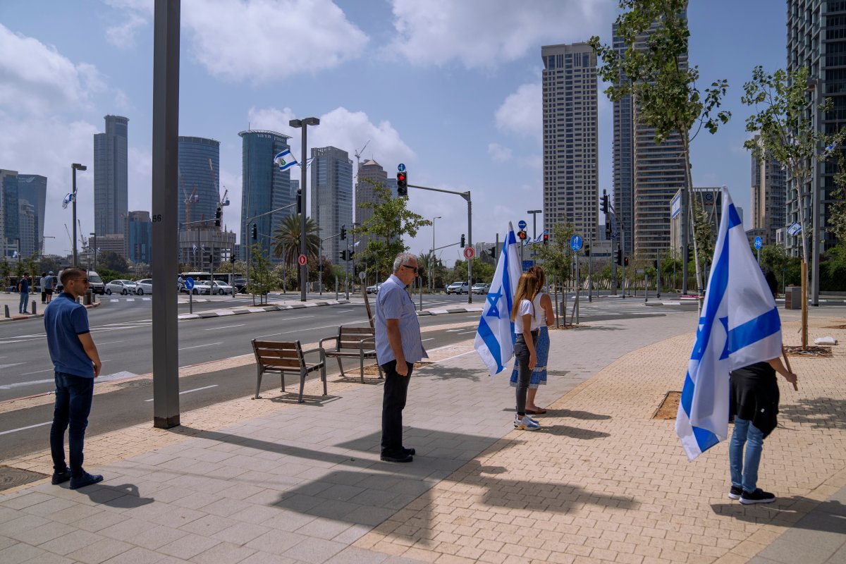Israelis stand still to observe two minutes of silence as air raid sirens sound to mark Israel's annual Memorial Day for fallen soldiers in Tel Aviv, Israel, Wednesday, May 4, 2022.