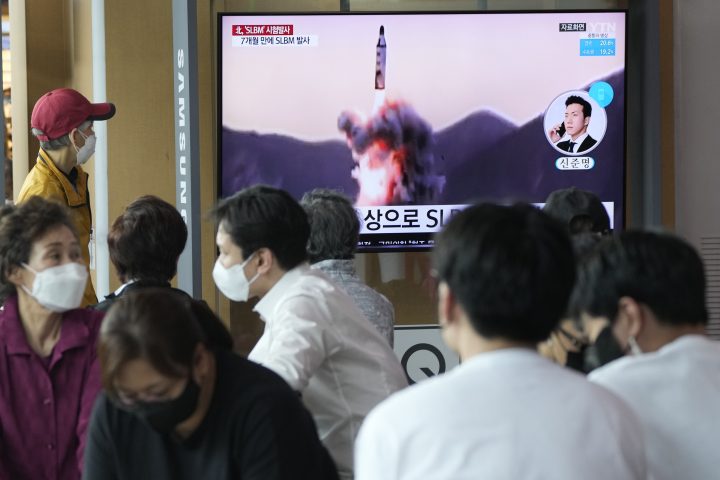 People watch a TV showing a file image of North Korea's missile launch during a news program at the Seoul Railway Station in Seoul, South Korea, Saturday, May 7, 2022. 