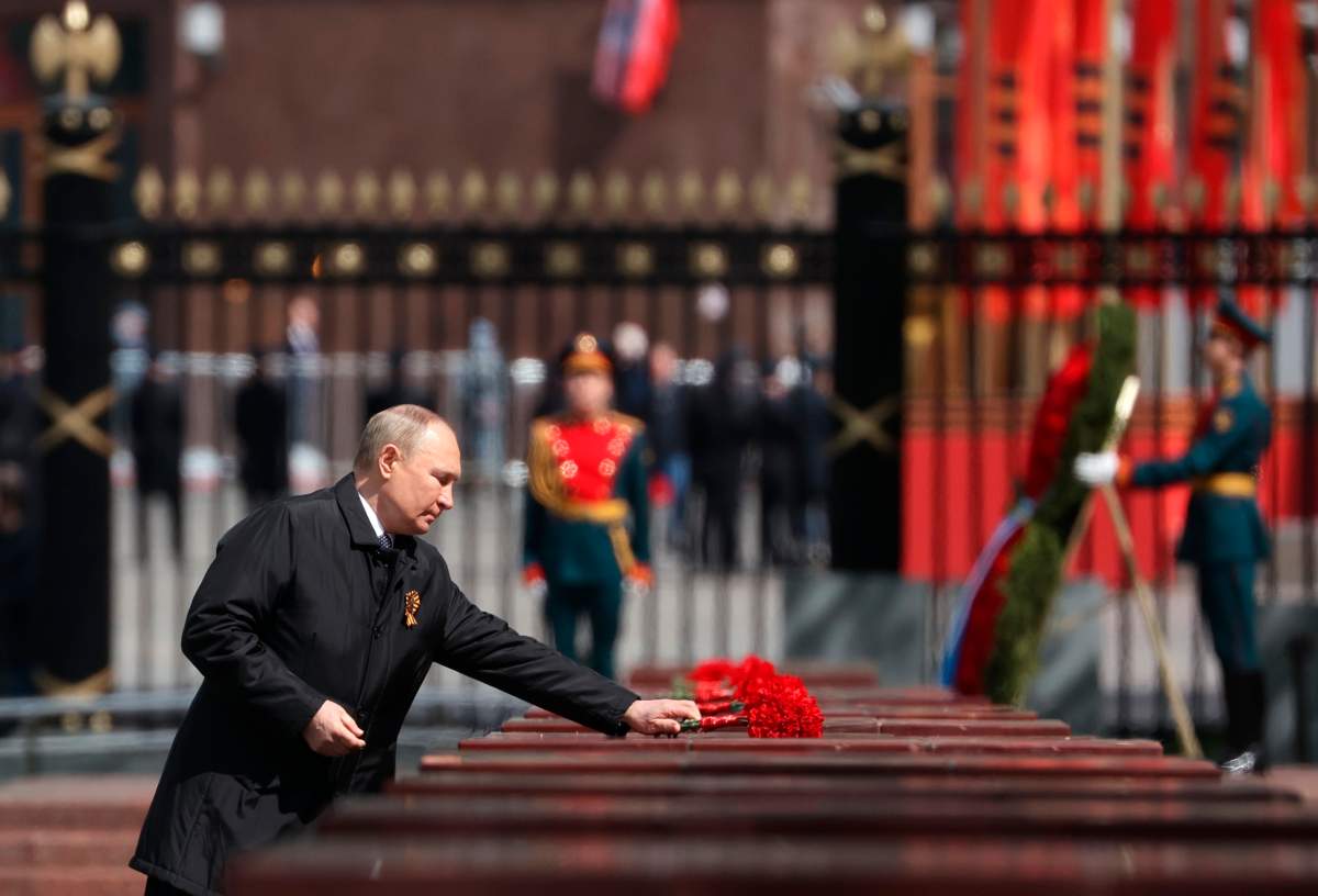 Russian President Vladimir Putin places a wreath on the Tomb of the Unknown Soldier after the military parade marking the 77th anniversary of the end of World War II in Moscow, Russia, Monday, May 9, 2022.