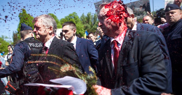 Russia’s ambassador to Poland doused in red by Ukraine war protesters