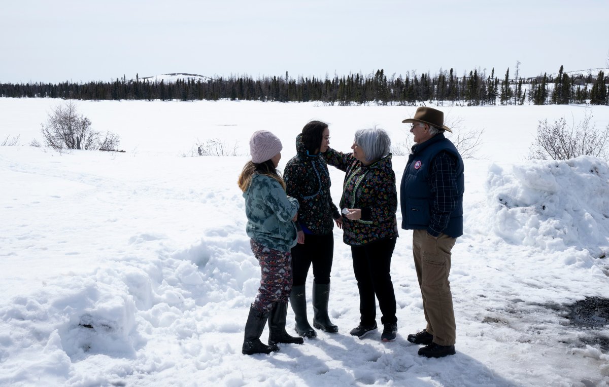 Governor General Mary Simon hugs Sarah May and Laura May(left) as husband Whit Fraser looks on as they visit the Isuarsivik Recovery Centre Warmak at the Three Lakes site
in Kuujjuaq, Que., Monday, May 9, 2022.  