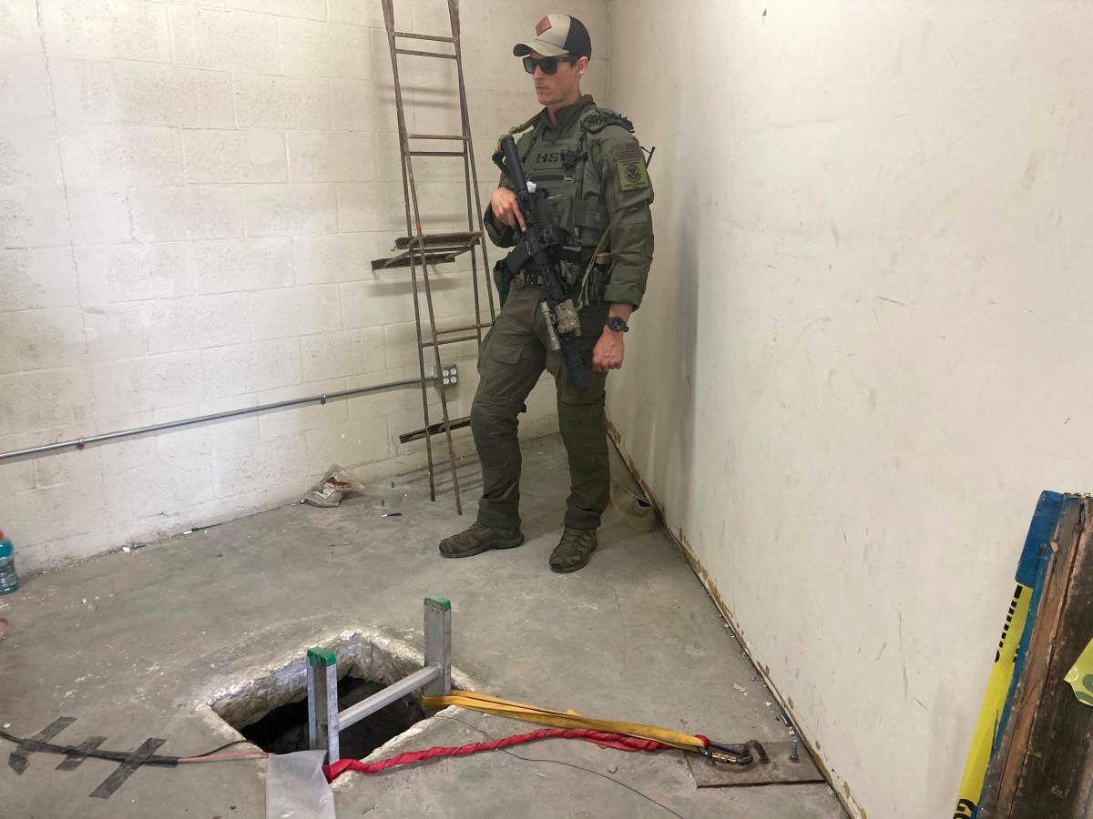 A law enforcement officer stands by the opening of a cross-border tunnel on Monday, May 16, 2022 between Mexico's Tijuana into the San Diego area.