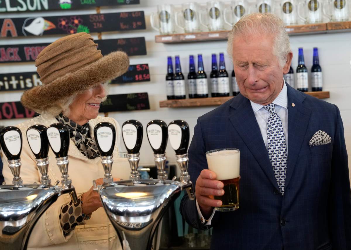 Prince Charles reacts to a bad pour of beer he made at the Quidi Vidi Brewery as Camilla, Duchess of Cornwall looks on during their Canadian Royal tour in St. John’s, Tues