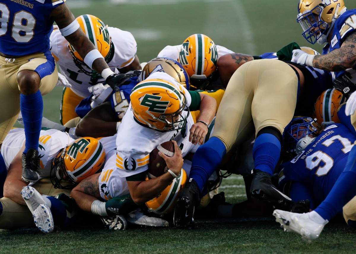 Edmonton Elks quarterback Taylor Cornelius (15) drives through for the touchdown against the Winnipeg Blue Bombers during the first half of pre-season CFL action in Winnipeg, Friday, May 27, 2022. THE CANADIAN PRESS/John Woods