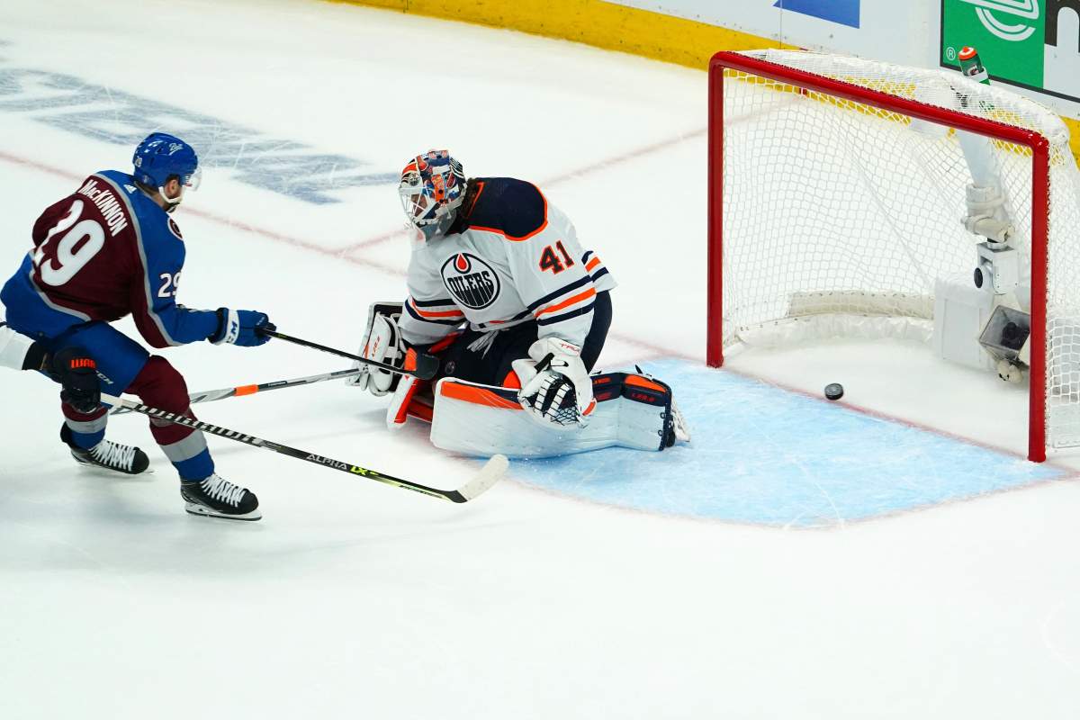 Colorado Avalanche center Nathan MacKinnon (29) scores a goal against Edmonton Oilers goaltender Mike Smith (41) during the first period in Game 1 of the NHL hockey Stanley Cup playoffs Western Conference finals Tuesday, May 31, 2022, in Denver. (AP Photo/Jack Dempsey)