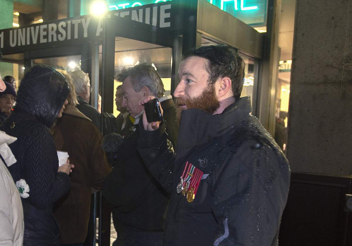 Jeremy MacKenzie, right, a Canadian military veteran who served in Afghanistan, talks with an unidentified woman outside the venue where Omar Khadr, the former child soldier is speaking in Halifax on Monday, February 10, 2020. The Roméo Dallaire Child Soldiers Initiative, in partnership with Dalhousie University's Open Dialogue series, is hosting the event with keynote speakers Khadr and Ishmael Beah. Several veterans gathered outside the facility as a protest. THE CANADIAN PRESS/Andrew Vaughan.