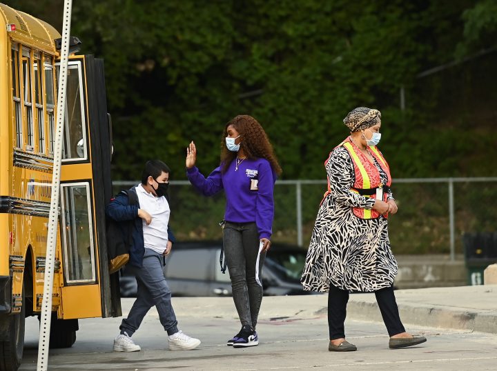 Children arrive by bus at Portage Trail Community School which is part of the Toronto District School Board (TDSB) .