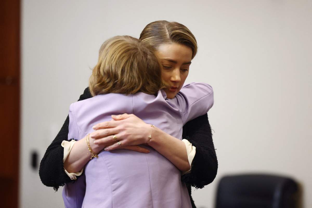 US actress Amber Heard embraces a member of her legal team as she arrives at the Fairfax County Circuit Courthouse in Fairfax, Virginia, on May 5, 2022.