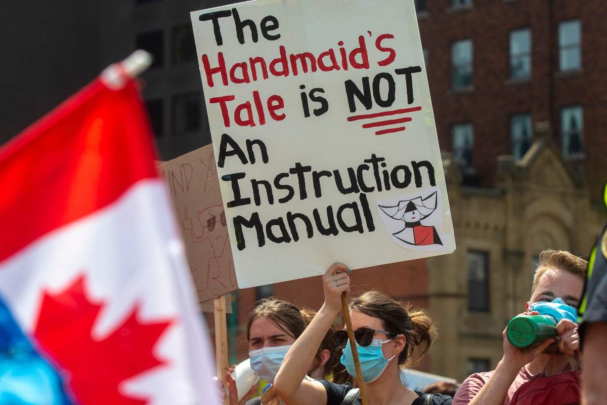 A pro-choice counter-protester holds a sign on the sidelines of the pro-life National March for Life in Ottawa, Ontario, on May 12, 2022. – The protest comes amid a political firestorm in the United States ignited by a leaked draft opinion that showed the Supreme Court’s conservative majority preparing to overturn Roe v. Wade, a landmark 1973 ruling guaranteeing abortion access nationwide.