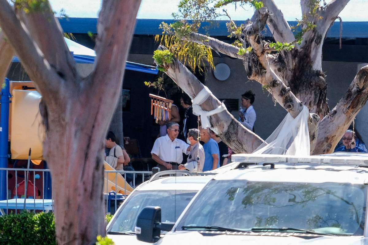 Churchgoers are seen as police investigate after a shooting inside Geneva Presbyterian Church in Laguna Woods, California, on May 15, 2022. - One person was dead and four people were "critically" injured in a shooting at a church near Los Angeles, law enforcement said Sunday.