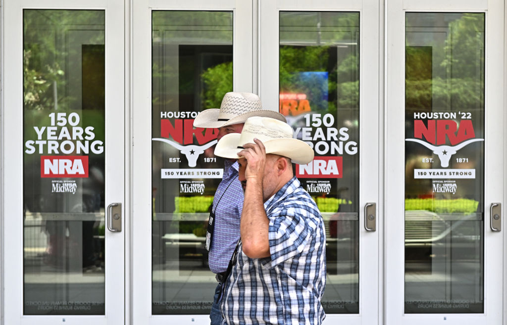 People walk outside the George R. Brown Convention Center in Houston Friday as the NRA Convention is held a few days after the Robb Elementary school shooting in Uvalde, Texas.