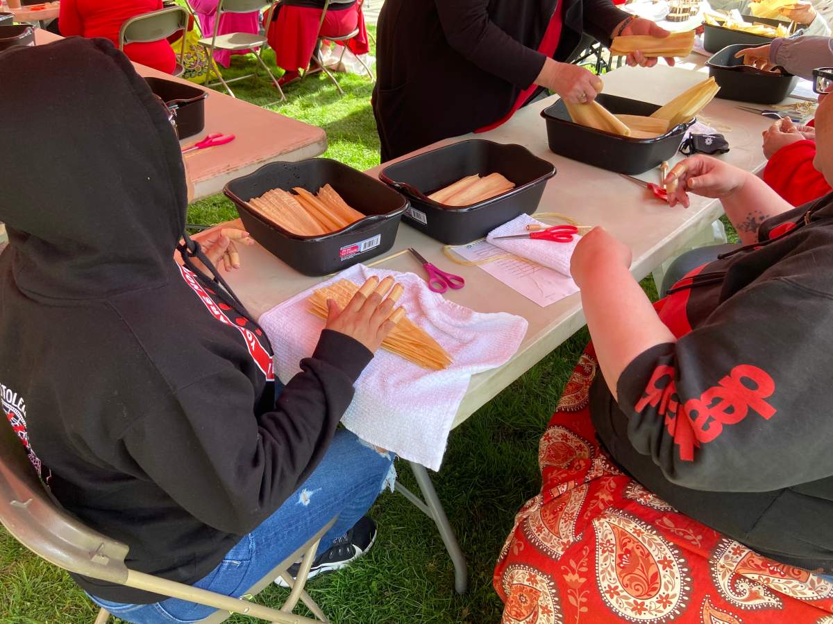 Corn doll making at the Red Dress Day event at the London, Ont. Peace Garden in Ivey Park