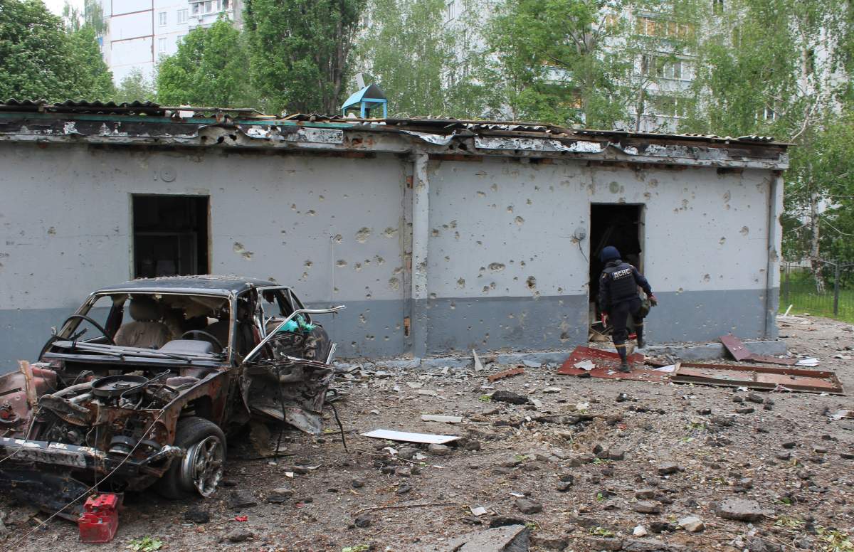 Emergency worker clears rocket debris from residential neighbourhood of Kharkiv, May 20, 2022.