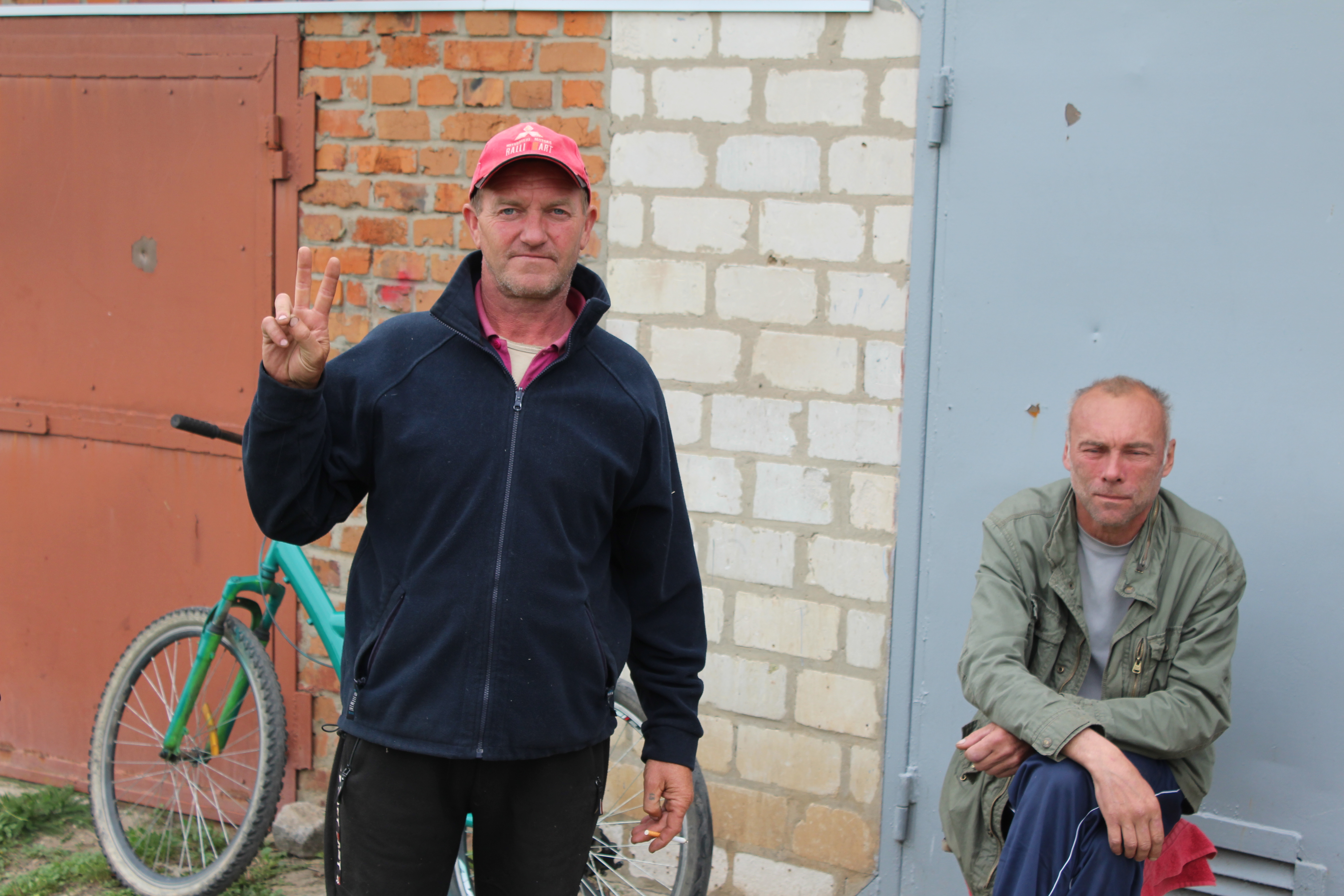 Gennadiy Novikova, left, lost his mother to Russian shelling of Vilkhivka, Ukraine.
