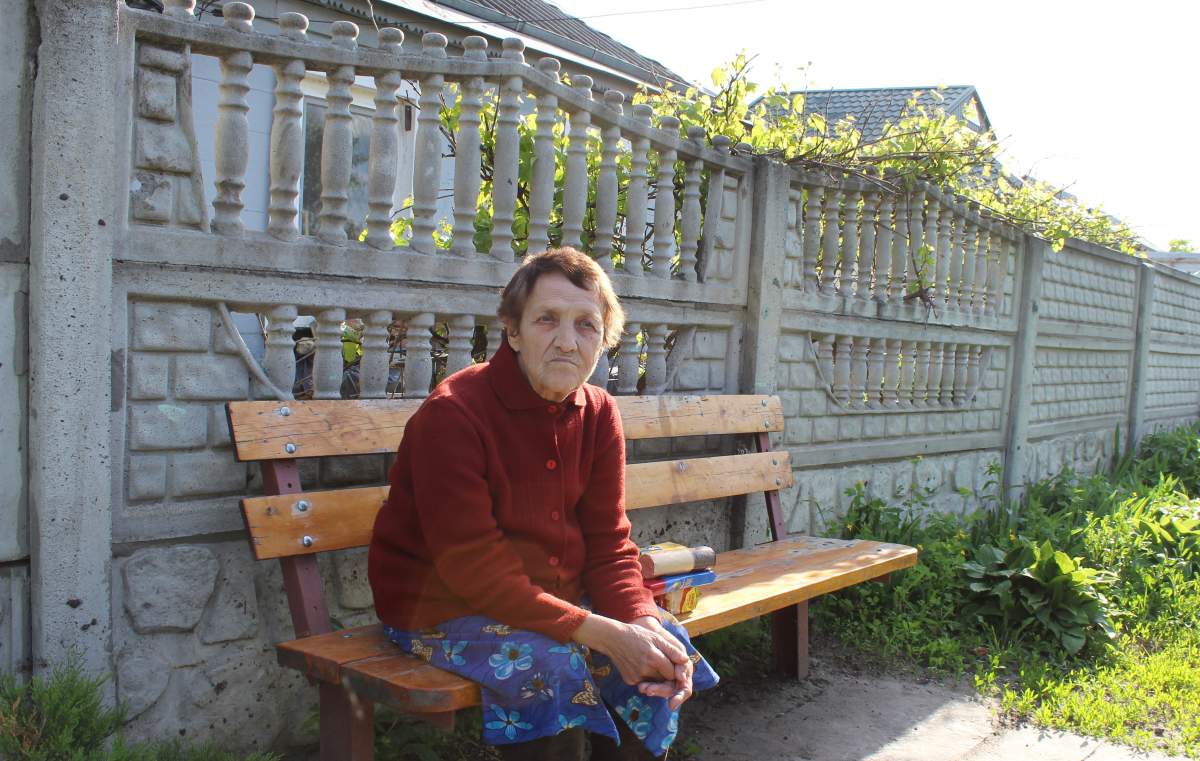 Helena Yehorova outside her house in Ruska Lozova, Ukraine, May 27, 2022.
