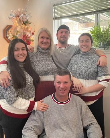 An undated photo of Mitchell Donoghue (C) with his family.