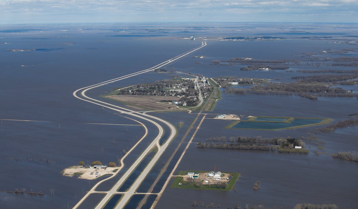 St Jean Baptiste, Man., which runs along Highway 75, is protected against Red River flooding by a dike south of Winnipeg May 15. A section of Hwy 75 closed since the beginning of May reopened Friday.