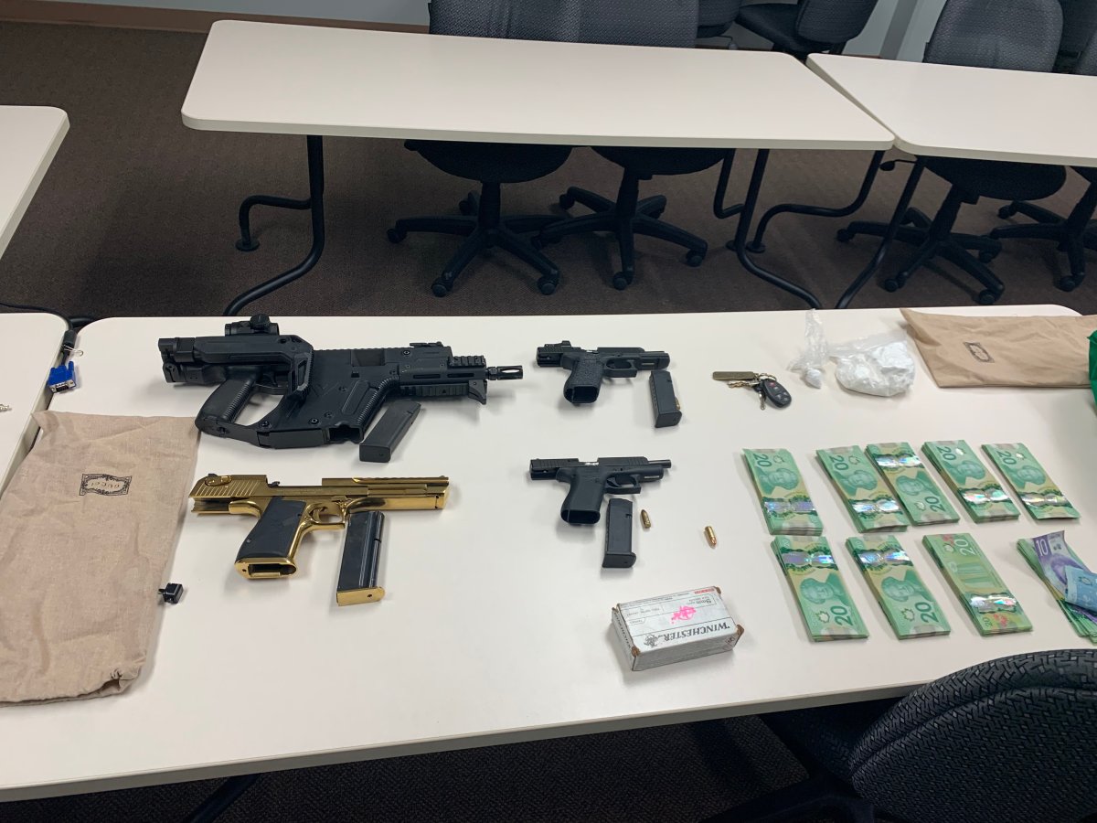 An undated photo of firearms, drugs and cash seized by Strathmore RCMP from a man police believe was involved in a gun store break and enter near Medicine Hat.