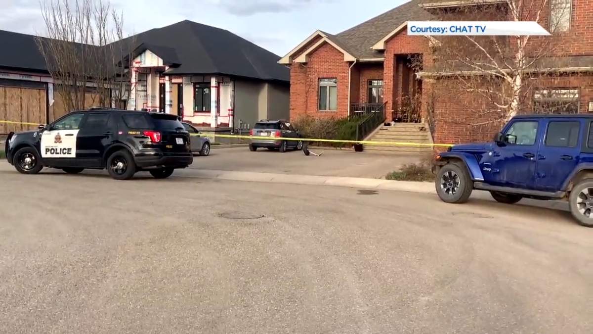 Police tape cordons off the area with debris from a plane crash in Medicine Hat, pictured on May 3, 2022.