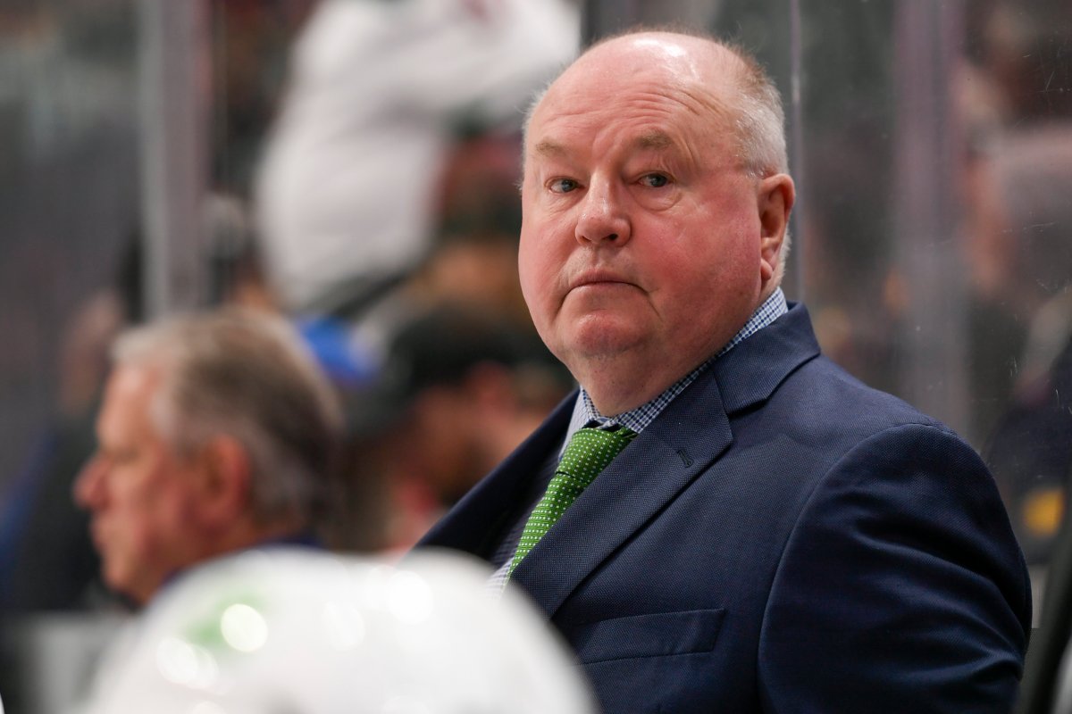 Vancouver Canucks coach Bruce Boudreau, seen here looking on during a road game against the Minnesota Wild on April 21, 2022, will return as the team’s head coach for the 2022-23 season.