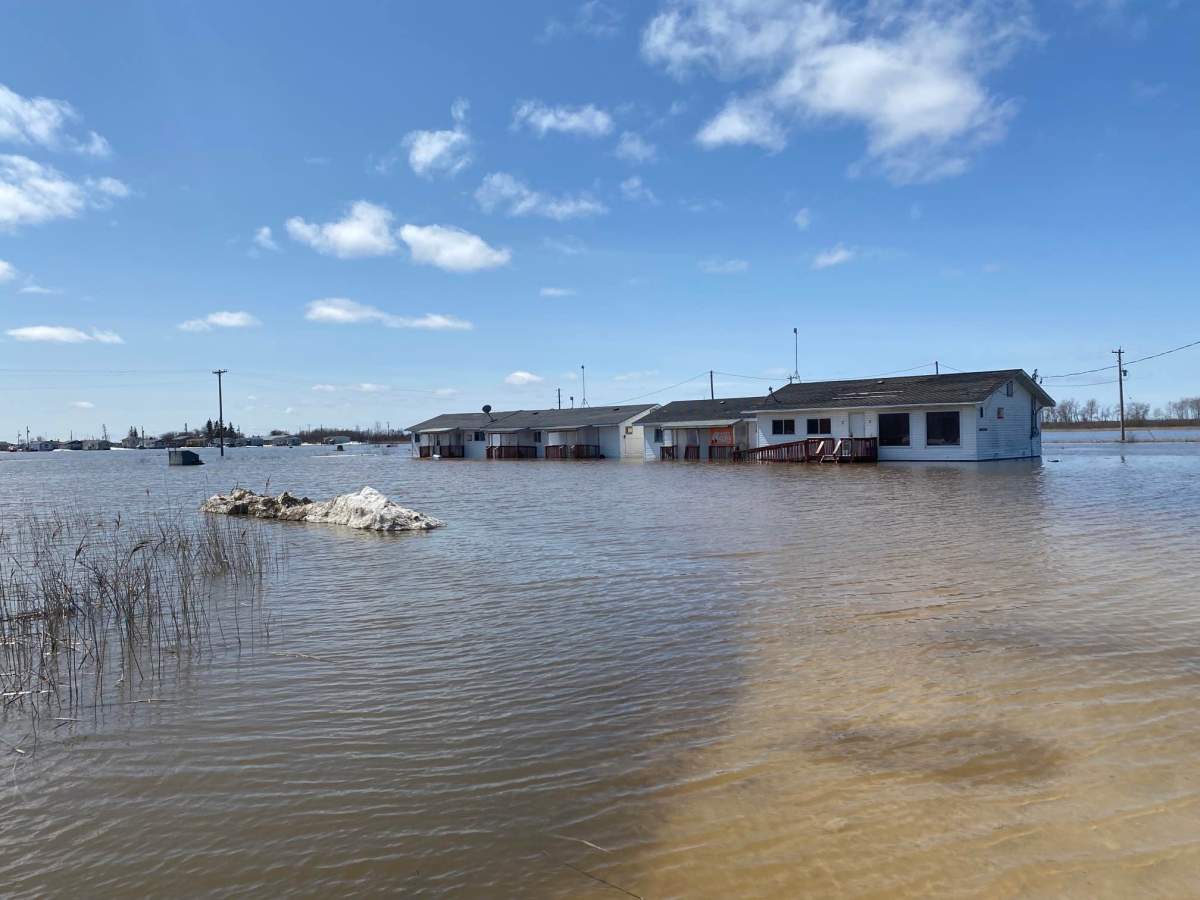 Water surrounds a home on Peguis First Nation Tuesday.