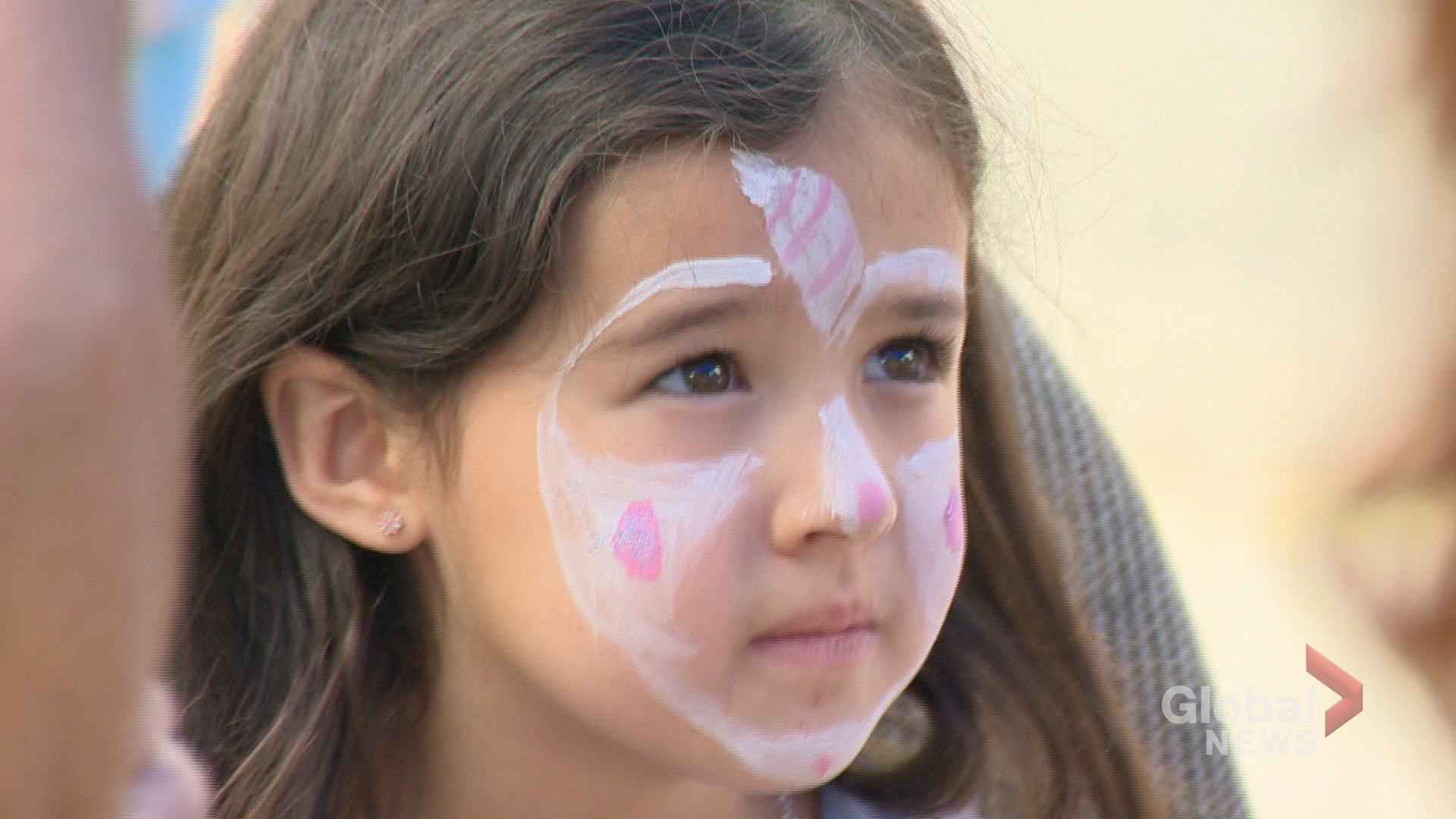 Young girl gets her face painted at Cathedral Village Street Fair.
