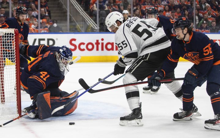 Los Angeles Kings’ Quinton Byfield (55) is stopped by Edmonton Oilers’ goalie Mike Smith (41) as Kailer Yamamoto (56) defends during first period NHL playoff action in Edmonton on Wednesday, May 4, 2022.