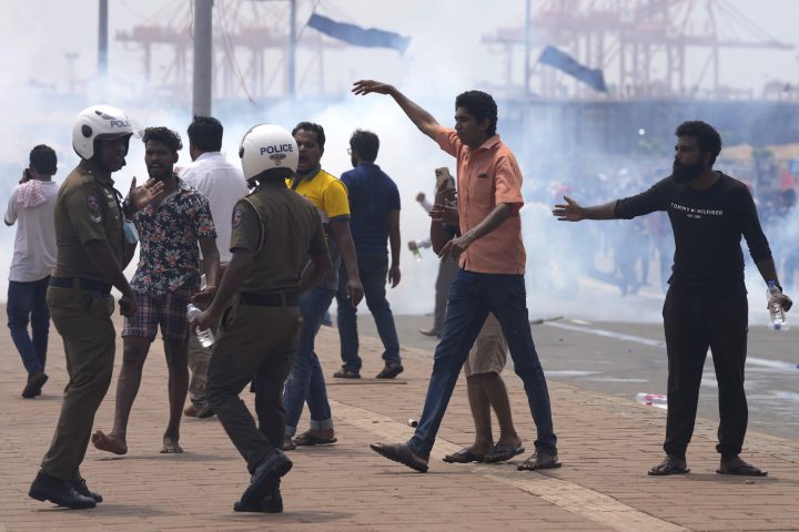 Sri Lankan government supporters make an attempt to attack anti-government protesters outside president’s office residence in Colombo, Sri Lanka, Monday, May 9, 2022.