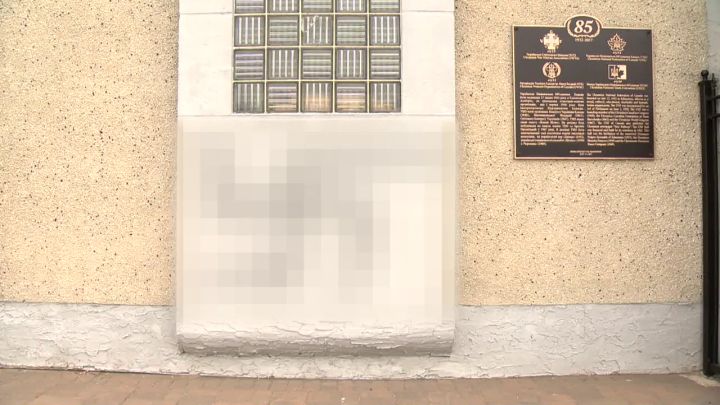 On Friday, swastikas were found spraypainted on Edmonton’s Ukrainian National Federation Hall as well as on a “Stop Putin, Stop War” banner hanging just next to the building. Global News has decided to blur the swastika images.