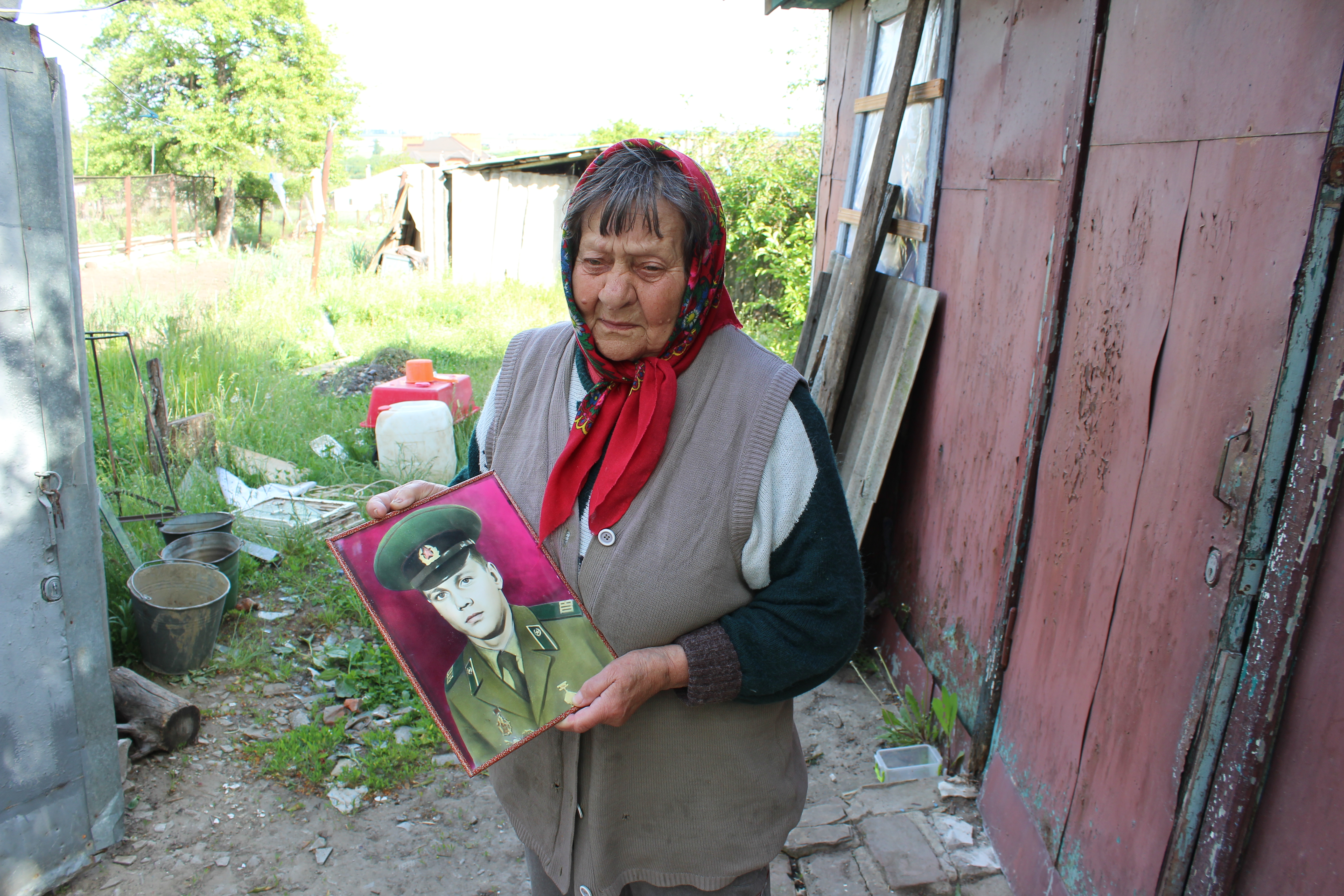Stefania Leskiv, whose home was destroyed by a rocket, with photo of her late son.