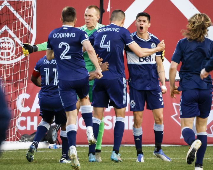 Vancouver Whitecaps defender Cristian Gutierrez celebrates his game-winning goal with teammates in a shoot out over the Calgary Cavalry during soccer action in the Canadian Championship quarter-finals in Calgary, Alta., Wednesday, May 25, 2022.