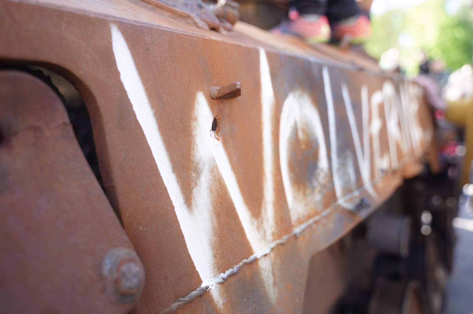 Old Soviet tank with Wolverines spray-painted on side.