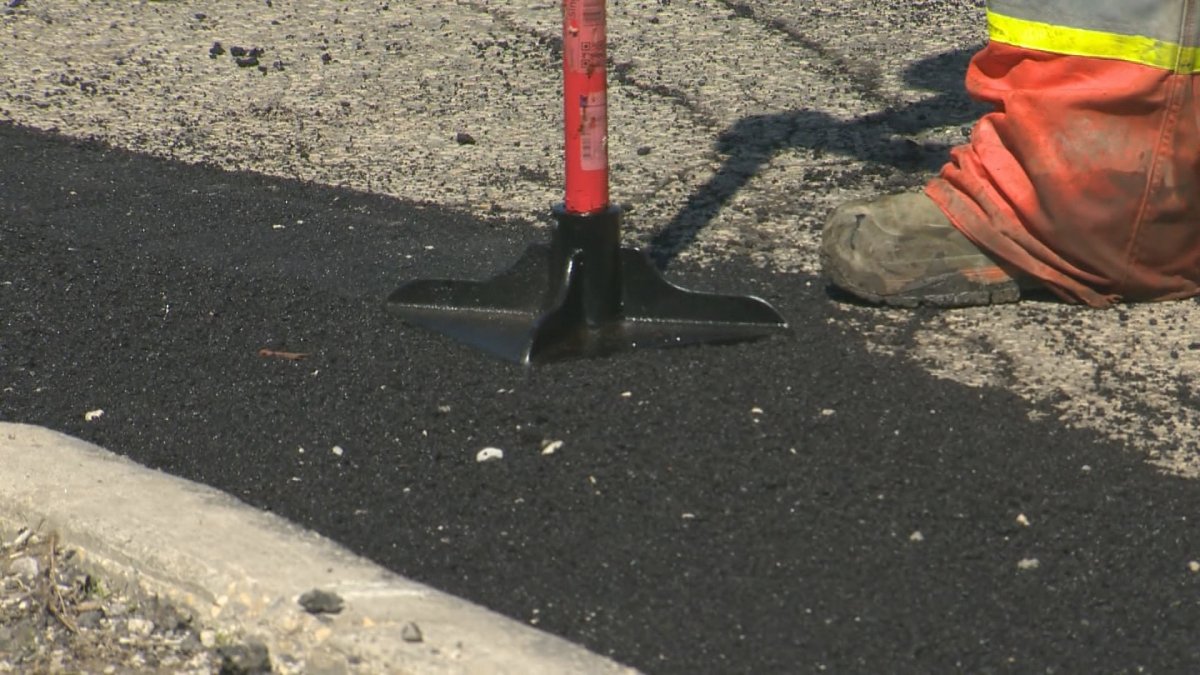 Crews use hot asphalt to fix a pothole in Winnipeg.