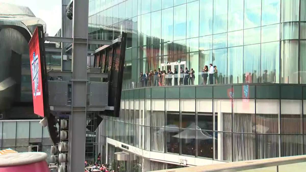 Guests at Jasin Dhaliwal and Manika Chopra-Dhaliwal’s wedding cheer on their respective teams as the Battle of Alberta played in Ice District Plaza Sunday, May 22, 2022.