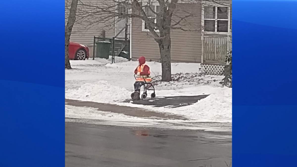 Jane Boudreau sits at the crosswalk in winter.