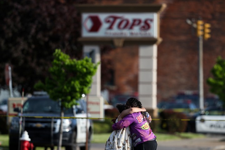  People hug outside the scene after a shooting at a supermarket on Saturday, May 14, 2022, in Buffalo, N.Y.