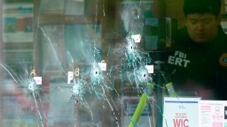 Bullet holes are visible in the glass of a Buffalo supermarket where a racially motivated shooting attack took place on the weekend.