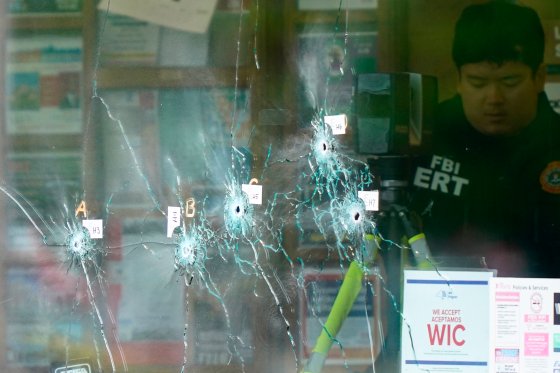 Bullet holes are visible in the glass of a Buffalo supermarket where a racially motivated shooting attack took place on the weekend.