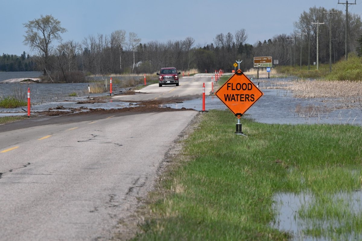 Water is seen crossing Highway 307.