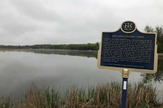 A sign describes the historical significance of the Holland Landing, a naval depot during the War of 1812