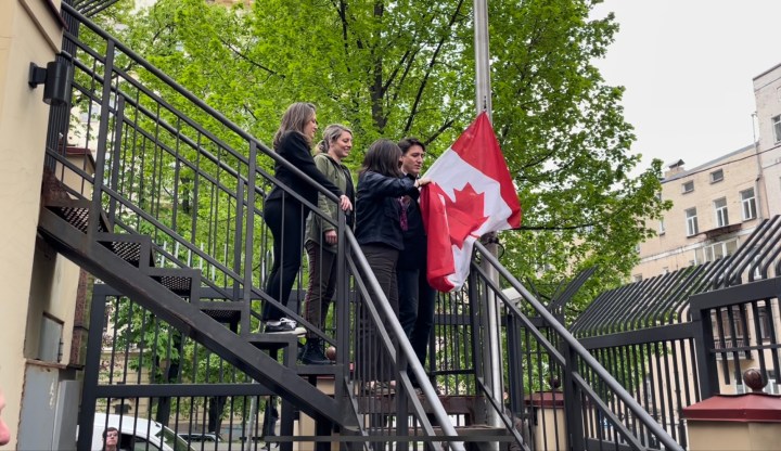 Prime Minister Justin Trudeau and Canadian ministers raise the Canadian flag at the embassy in Kyiv, Ukraine, during a surprise trip to the country on May 8, 2022.