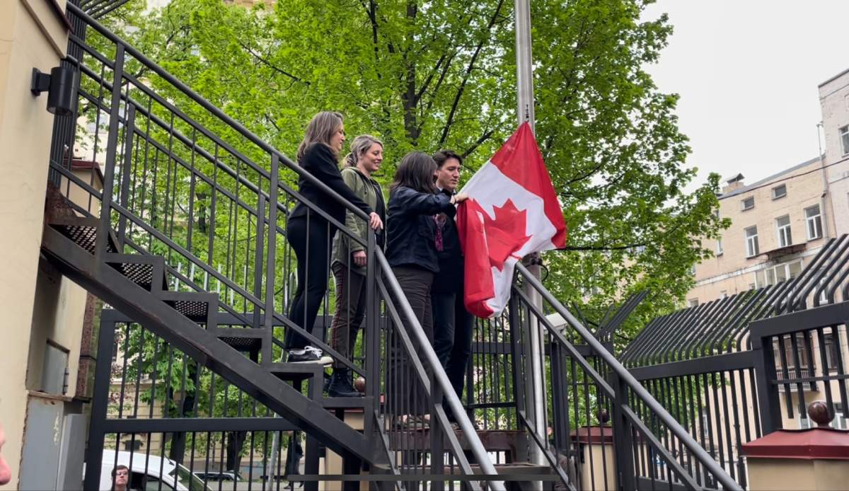 Prime Minister Justin Trudeau and Canadian ministers raise the Canadian flag at the embassy in Kyiv, Ukraine.