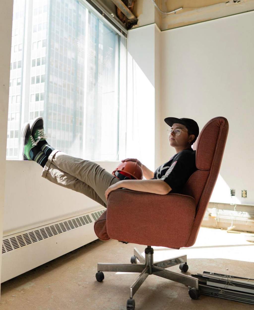 K Kealey takes a break at work, putting their feet up and enjoying a view of Calgary.