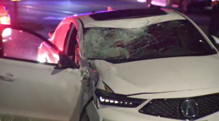 A damaged white sedan at the scene of the crash in Richmond Hill.