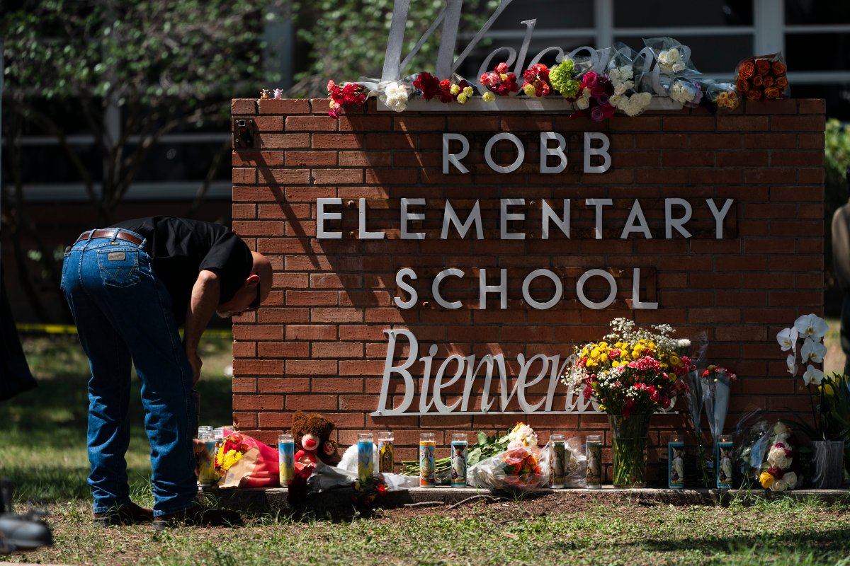 The Robb Elementary School sign decorated with flowers in memorial of the 21 dead in the May 24 school shooting.