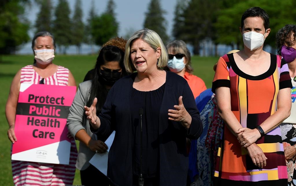Ontario NDP Leader Andrea Horwath stands beside Ottawa West-Nepean candidate Chandra Pasma, right, and nurses, left, as she speaks during a campaign event at a park in Ottawa, on Tuesday, May 31, 2022. 