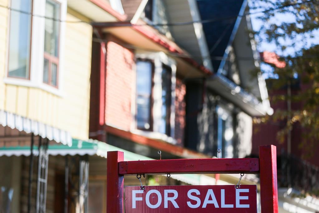 A for sale sign is displayed in front of a house in the Riverdale area of Toronto on Wednesday, Sept. 29, 2021.
