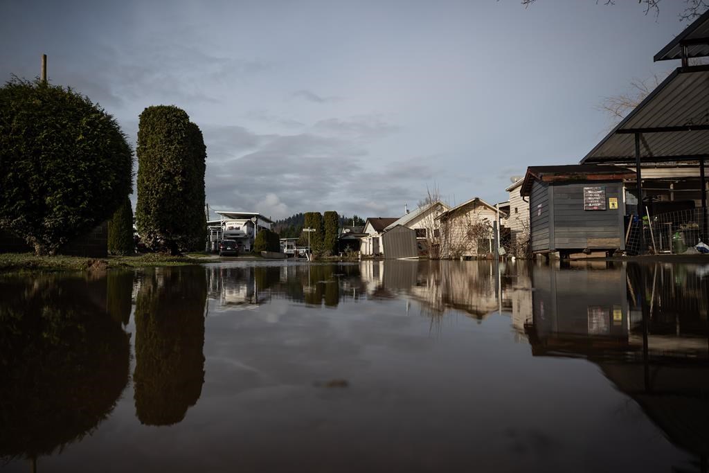 Floodwaters cover a road after water began to recede at Everglades Resort on Hatzic Lake near Mission, B.C., on Sunday, December 5, 2021. Evacuation orders have been issued for three small communities in northwestern British Columbia as the flood risk rises across the region. 